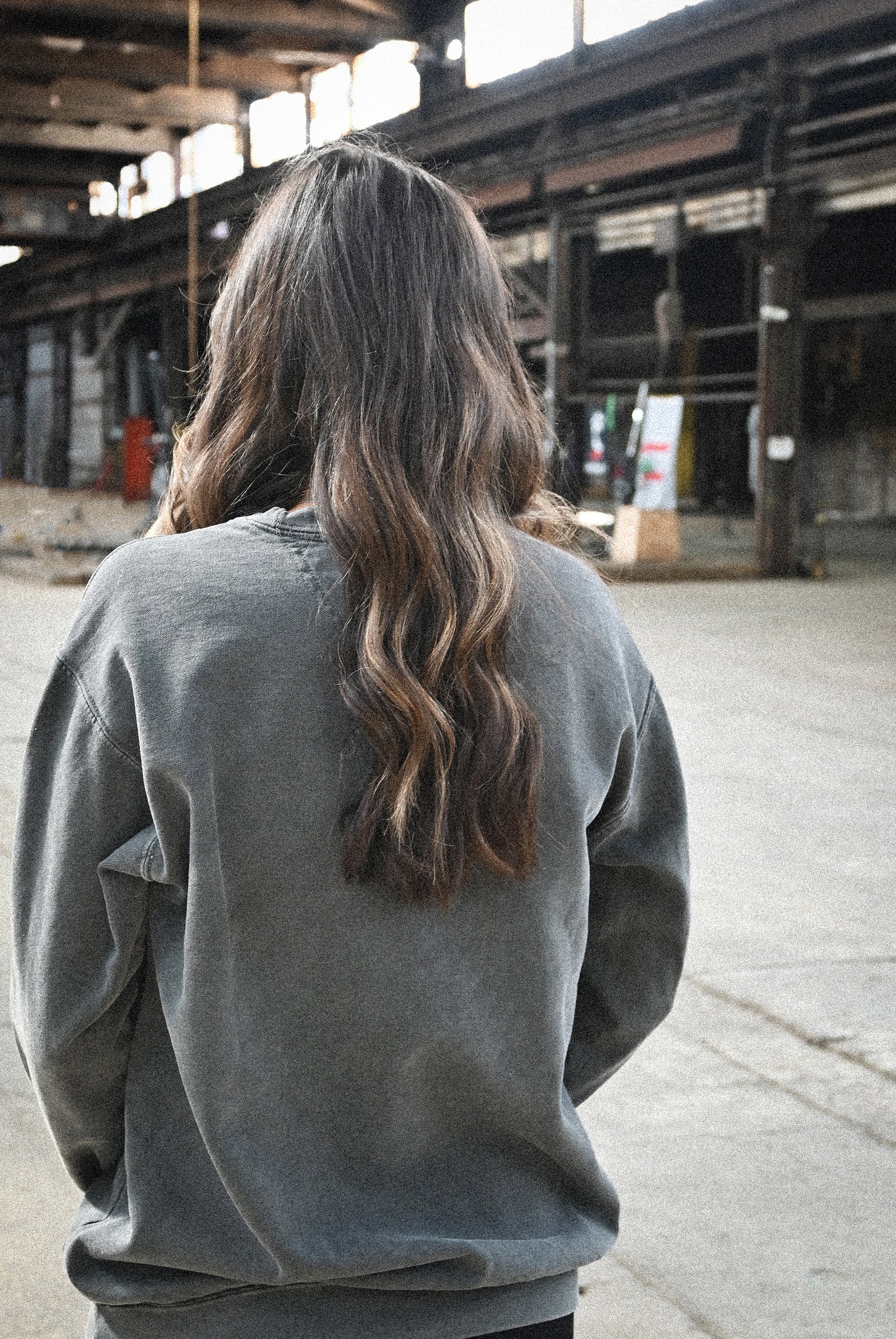 Fetch Boy Unisex Heavyweight Crewneck Sweatshirt in Steel Gray in Industrial Setting.
