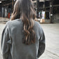 Fetch Boy Unisex Heavyweight Crewneck Sweatshirt in Steel Gray in Industrial Setting.